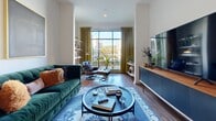 Located at 1045 Old Peachtree Rd NW in Suwanee, GA, this thoughtfully designed one-bedroom, one-bathroom residence offers a comfortable and stylish living experience across a single floor. The open-concept layout seamlessly connects the living room and kitchen, creating a welcoming and functional common area. Large floor-to-ceiling windows in the living room flood the space with natural light and offer outdoor views, complementing the rich hardwood-style flooring throughout. The kitchen is outfitted with stainless steel appliances, white shaker cabinetry, a hexagonal tile backsplash, and a granite-topped island with bar seating beneath pendant lighting — ideal for both cooking and entertaining. The spacious primary bedroom features plush carpet, a striking decorative accent wall, and oversized windows that continue the theme of natural light and outdoor connectivity. A dedicated closet provides ample storage. The bathroom is clean and bright, featuring a full soaking tub with subway tile surround and polished chrome fixtures. Throughout the residence, crisp white walls and an open, airy feel create a modern yet inviting ambiance well-suited for everyday living.