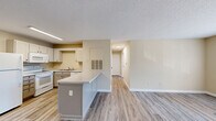 Located at 3691 Clay Pond Rd in Myrtle Beach, SC, this single-floor, 2-bedroom, 2-bathroom home offers a functional and comfortable layout throughout. The open-concept main living area seamlessly connects the kitchen, dining, and living spaces, all finished with light wood-look flooring and warm beige walls that create a bright, cohesive atmosphere. Textured ceilings add a classic touch throughout the home.

The kitchen is well-equipped with gray cabinetry, white appliances including a refrigerator, range, microwave, and dishwasher, and a peninsula island that provides additional counter space and separates the kitchen from the living area. Recessed fluorescent lighting illuminates the workspace efficiently.

Both bedrooms are comfortably sized, featuring natural light from large windows with blinds, ceiling fans, and easy access to closets. The primary bedroom offers a generous layout with its own closet. The two bathrooms are cleanly finished, one featuring a white vanity with framed mirror and a tub/shower combination, and the other appointed with matching fixtures and wood-look flooring. A dedicated laundry room adds everyday convenience. The hallway connects all rooms with an efficient flow, making this home practical for a variety of lifestyles.