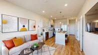 Located at 2230 Peregrine Dr in Brighton, Colorado, this 2-bedroom, 2-bathroom single-floor home offers a thoughtfully designed open-concept layout that maximizes every inch of its space. Light wood-tone flooring flows throughout the main living area, connecting the living room and kitchen in a seamless, cohesive fashion.

The living room is bright and welcoming, with large windows that invite natural light and provide views of the surrounding neighborhood. The modern kitchen is a standout feature, equipped with white shaker cabinetry, a full suite of stainless steel appliances, a subway tile backsplash, and a central island with pendant lighting overhead — ideal for casual dining or meal prep. A convenient in-unit washer and dryer is tucked neatly alongside the kitchen area.

Both bedrooms are carpeted and feature large windows with exterior views, creating comfortable, naturally lit retreats. The primary bedroom includes a dedicated closet for added storage. The two bathrooms are cleanly finished, with one featuring a glass-enclosed walk-in shower with large-format tile surround and wood-look flooring.

Recessed lighting throughout and a neutral color palette give the entire home a clean, modern aesthetic, making it a practical and attractive residence in the Brighton community.