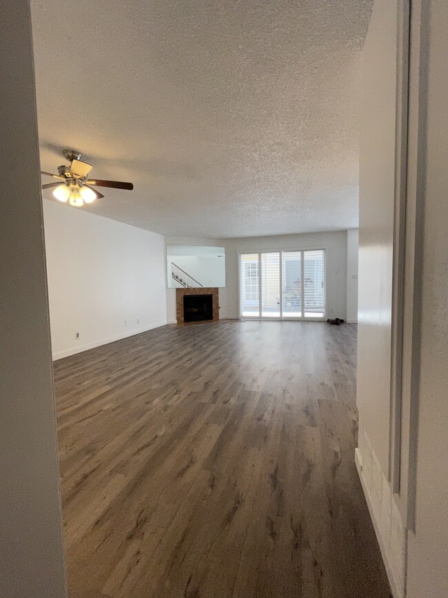 Living room with fireplace and plantation shutters - 227 W Palm Ave