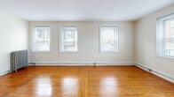 Located at 2 Copley Rd in Upper Darby, PA, this 2-bedroom, 1-bathroom unit offers a well-organized single-floor layout with a practical mix of classic and functional design elements. Warm hardwood floors run throughout most of the unit, lending a timeless character to the living spaces.

The living room is an inviting, light-filled area accessed through a distinctive arched entryway. Three windows along the exterior wall bathe the room in natural light and offer street views, while baseboard heating ensures year-round comfort.

Both bedrooms are generously proportioned, each featuring hardwood floors and multiple windows. The primary bedroom includes a classic cast-iron radiator, adding a charming architectural detail. The second bedroom also benefits from ample natural light. Two closets provide convenient storage throughout the unit.

The kitchen is a functional galley-style space equipped with warm wood cabinetry, granite-look countertops, a gas range, and a refrigerator. Light vinyl plank flooring and a window add brightness to the room.

The bathroom features classic light blue tile surrounding a full soaking tub, complemented by mosaic tile flooring. A hallway connects the rooms, providing a clear and efficient flow throughout the unit. Two dedicated closets offer practical storage solutions.