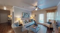 This single-story residence offers two bedrooms and two full bathrooms within a thoughtfully designed floor plan. The living room serves as the heart of the home, featuring crown molding, a ceiling fan, and hardwood-style flooring. Natural light filters in through a glass door fitted with blinds and framed by warm drapery, creating an inviting atmosphere. The space flows seamlessly into a dedicated dining area, distinguished by an elegant chandelier overhead and crown molding that adds a refined touch.

The galley-style kitchen is well-equipped, showcasing rich wood cabinetry, granite countertops, stainless steel appliances, and durable hardwood-style flooring. Ample counter and storage space make it highly functional.

Both bedrooms are carpeted and feature crown molding and ceiling fans. Each offers a comfortable, private retreat. The bathrooms are finished with granite-top vanities, wood cabinetry, and tub/shower combinations.

Throughout the residence, a neutral color palette and consistent architectural detailing—including crown molding and wood-style flooring in common areas—contribute to a cohesive, polished aesthetic.