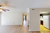 Located at 730 Germantown Cir in East Ridge, Tennessee, this single-story, two-bedroom, one-bathroom home offers a practical and comfortable layout across a well-proportioned floor plan. Light-toned wood-look flooring flows throughout the main living areas and bedrooms, complemented by neutral walls and textured ceilings that create a clean, consistent aesthetic.

The open living room is a standout feature, bathed in natural light from two large windows and anchored by a ceiling fan with light fixture. Sliding glass doors lead to an outdoor view, further enhancing the bright, airy atmosphere. The kitchen is efficiently designed with tile flooring, dark cabinetry, white appliances including a refrigerator and dishwasher, and a pendant light over the pass-through opening that connects to the dining area.

A hallway leads to both bedrooms. The spacious primary bedroom offers generous room for furnishings, a walk-in closet with dual wire shelving, and a window overlooking greenery. The second bedroom is comparably sized with its own window admitting natural light. The full bathroom features a tub/shower combination, a vanity with a speckled countertop, and tile flooring. The home provides a comfortable, functional living environment in a residential East Ridge neighborhood.