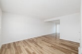 Located at 524 N Juanita Ave in Redondo Beach, California, this two-story home offers a clean, modern aesthetic throughout. Light wood-tone flooring runs continuously across both levels, creating a bright and cohesive feel that complements the crisp white walls and abundant natural light.

The main level features an open living and dining area with sliding glass door access to an outdoor space, accented by a sputnik-style chandelier. The galley-style kitchen is well-appointed with two-tone cabinetry, white quartz countertops, stainless steel appliances including a range, microwave, and refrigerator, and a deep undermount sink beneath a window. A convenient half bathroom is also found on this floor.

Upstairs, multiple bedrooms offer comfortable proportions, each fitted with ceiling fans and ample natural light from windows with blinds. One bedroom features a sliding glass door opening to a private balcony with neighborhood views. A full bathroom on the upper level includes a soaking tub with overhead rain shower, modern vanity with wood-tone cabinetry, and a window for natural ventilation.

A staircase with white railings connects the two floors, reinforcing the home's clean, contemporary design. The overall ambiance is light, airy, and move-in ready.