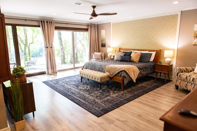 Master bedroom with comfortable King bed, views of the Brazos River, a desk, smart TV &lounge chair - 967 Greenwood Ln