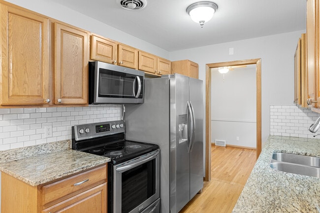 Chef's kitchen, professionally cleaned, original woodwork, deep gauge sink & kitchen window! - 7131 Ewing Ave N