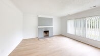 Located at 28509 Franklin Rd in Southfield, Michigan, this single-floor, 2-bedroom, 1-bathroom home offers a clean, modern aesthetic with a bright and airy feel throughout. The living room serves as the heart of the home, featuring a classic brick fireplace as a focal point, light hardwood flooring, a textured ceiling, and a large window with vertical blinds that frames a lush outdoor view. An elegant arched doorway connects the living area to the kitchen, which is outfitted with crisp white cabinetry, black hardware accents, and marble-style countertops — all complemented by light hardwood floors and a window overlooking the outdoors. Both bedrooms are comfortable and well-lit, each featuring plush carpeting, vertical blinds, and windows that invite natural light. The bathroom is finished in a cohesive modern style with white cabinetry, a clean white countertop, light hardwood flooring, matte black fixtures, and a window providing natural ventilation. A dedicated laundry room with side-by-side washer and dryer adds everyday convenience. The hallway connects all areas seamlessly, completing this well-organized and thoughtfully updated single-level home.