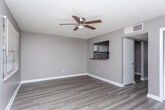 Located at 1200 Kingstown Ct in Albany, Georgia, this single-floor unit offers a straightforward and functional layout designed for comfortable everyday living. Throughout the main living areas and bedroom, wood-look plank flooring provides a cohesive and easy-to-maintain surface, complemented by neutral gray walls and crisp white baseboards that create a clean, understated aesthetic. Textured ceilings with ceiling fans are found in key rooms, adding to the practical character of the space.

The living area is open and well-proportioned, featuring a pass-through window that connects directly to the kitchen, enhancing the flow between spaces. A exterior door with a paneled design and a window with blinds allow natural light to fill the room. The kitchen is equipped with white upper and lower cabinetry, dark countertops, a stainless steel sink, and an overhead range hood, providing ample storage and workspace for daily meal preparation.

The bedroom is generously sized and includes a sliding-door closet with built-in shelving, a built-in vanity countertop with a mirror and vanity lighting, and a ceiling fan overhead. The full bathroom features tile flooring, a vanity with under-sink cabinet storage, a mirror with overhead lighting, a toilet, and a tub-shower combination, rounding out the functional amenities of this well-appointed unit.