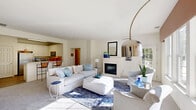 Located at 1000 Bally Bunion Dr in Egg Harbor City, NJ, this two-story home offers a thoughtfully designed layout across two floors, with the main living spaces occupying the upper level. The bright and airy living room serves as the heart of the home, featuring a classic fireplace, plush carpeting, and large windows that frame lush outdoor views, flooding the space with natural light. A coordinating sitting area completes the welcoming ambiance. The kitchen is outfitted with white shaker cabinetry, stainless steel appliances including a refrigerator, range, and over-the-range microwave, and light hardwood-style flooring. A dedicated pantry adds convenient storage. The spacious primary bedroom offers generous proportions, soft carpeting, and ample room for a full furniture suite. The en-suite bathroom features both a soaking tub and a separate glass-enclosed shower, with natural light streaming through a window above the tub. A second bedroom and bathroom provide flexibility for guests. Additional highlights include five closets, a dedicated laundry room with full-size washer and dryer, a utility room, a balcony, and an attached garage. Carpeted stairs with clean white trim connect the floors, lined with wall art for a warm, personal touch throughout.