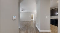 Located at 2506 Hope Way Lane in Charlotte, NC, this well-designed 2-bedroom, 2-bathroom single-floor home offers a thoughtful layout across a comfortable footprint. The open-concept living area features warm hardwood-style flooring, neutral gray walls, and a ceiling fan, creating an inviting and functional space. The kitchen is a standout, boasting dark espresso cabinetry, granite countertops, a peninsula with pendant lighting, and black appliances — all flowing seamlessly into the dining room, which features its own elegant chandelier. A dedicated entryway corridor connects the main living spaces efficiently.

The generously sized primary bedroom features plush carpeting, a large window with natural light, and access to a well-appointed en-suite bathroom with a dual-sink dark vanity, tile flooring, and a wide mirror with bright vanity lighting. The second bedroom is equally comfortable, with soft carpet and natural light from a large window. A dedicated laundry room provides added convenience, complete with a full-size washer and dryer and overhead shelving. Two closets offer ample storage throughout. The home's consistent use of neutral tones and quality finishes creates a clean, modern aesthetic throughout.