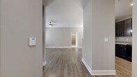Located at 2506 Hope Way Lane in Charlotte, NC, this well-designed 2-bedroom, 2-bathroom single-floor home offers a thoughtful layout across a comfortable footprint. The open-concept living area features warm hardwood-style flooring, neutral gray walls, and a ceiling fan, creating an inviting and functional space. The kitchen is a standout, boasting dark espresso cabinetry, granite countertops, a peninsula with pendant lighting, and black appliances — all flowing seamlessly into the dining room, which features its own elegant chandelier. A dedicated entryway corridor connects the main living spaces efficiently.

The generously sized primary bedroom features plush carpeting, a large window with natural light, and access to a well-appointed en-suite bathroom with a dual-sink dark vanity, tile flooring, and a wide mirror with bright vanity lighting. The second bedroom is equally comfortable, with soft carpet and natural light from a large window. A dedicated laundry room provides added convenience, complete with a full-size washer and dryer and overhead shelving. Two closets offer ample storage throughout. The home's consistent use of neutral tones and quality finishes creates a clean, modern aesthetic throughout.