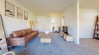 Located at 2555 Old Trevose Rd in Feasterville Trevose, PA, this single-floor residence offers three bedrooms, one bathroom, and a thoughtfully arranged layout across a comfortable footprint. The living room serves as the heart of the home, featuring soft carpeting, neutral walls, and ample space for seating and entertainment. Natural light filters in through windows, creating a bright and welcoming atmosphere. Adjacent to the living room, the dining area accommodates an intimate dining set beneath a ceiling fan, with a window providing outdoor views and a wall-mounted air conditioning unit for year-round comfort. The kitchen is equipped with warm honey-toned wood cabinetry, dark granite-style countertops, a tile backsplash, and white appliances including a gas range and refrigerator, complemented by tile flooring. The three bedrooms are carpeted and finished in soft neutral tones, each offering a calm and restful environment. The primary bedroom is generously sized with walk-in closet space. The full bathroom is finished with warm beige tile wainscoting, a soaking tub, a vanity with white cabinetry, and a large mirror, offering a clean and functional design. A connecting hallway ties all rooms together seamlessly.