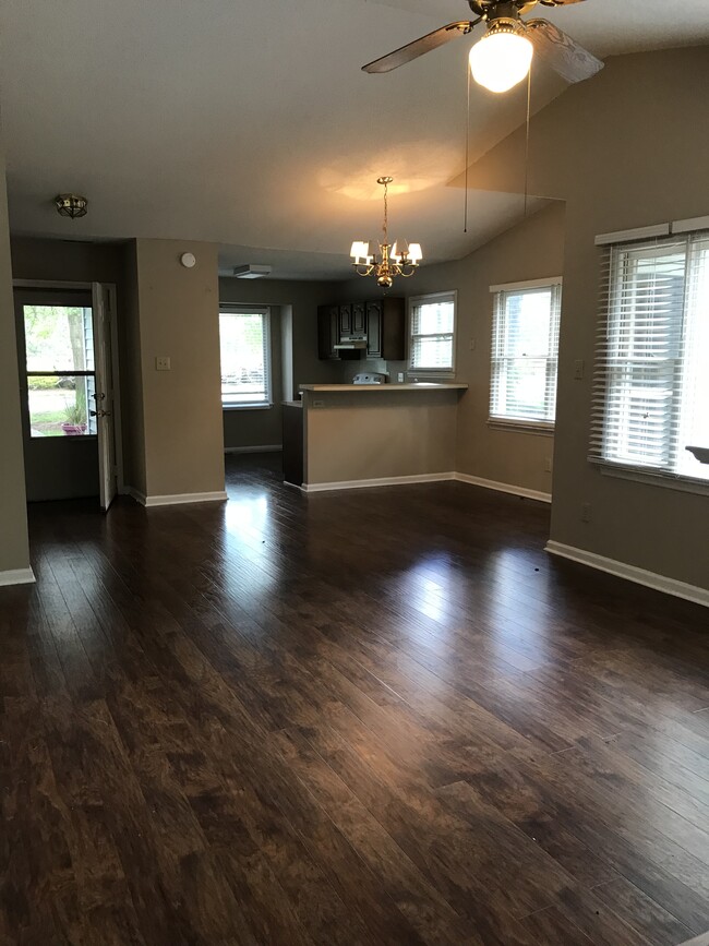 View of living room, dining area, kitchen and front door - 213 Standish Dr