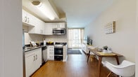 Located on the iconic Wilshire Boulevard in Los Angeles, this one-bedroom, one-bathroom unit offers a well-designed, efficient layout that maximizes every square foot. Warm hardwood-style flooring flows consistently throughout the space, lending a cohesive and polished look.

The kitchen is thoughtfully equipped with white cabinetry, dark granite countertops, and stainless steel appliances including a refrigerator, dishwasher, microwave, and range. Ample cabinet storage and a clean, functional design make it practical for everyday cooking.

The open living and dining area sits adjacent to the kitchen, bathed in natural light from a large window and glass door that frame views of the surrounding cityscape. The spacious primary bedroom continues the bright, airy feel with multiple windows fitted with blinds and sheer curtains, offering both light control and privacy.

A dedicated walk-in closet off the bedroom provides generous storage with built-in shelving and hanging rods. The bathroom features a full tub-shower combination with a clean white finish, a vanity with under-sink storage, and wood-tone flooring that ties into the rest of the unit.

A smart thermostat is also installed, adding a modern, energy-efficient touch. This unit offers a practical and comfortable living environment in a prime Los Angeles location.