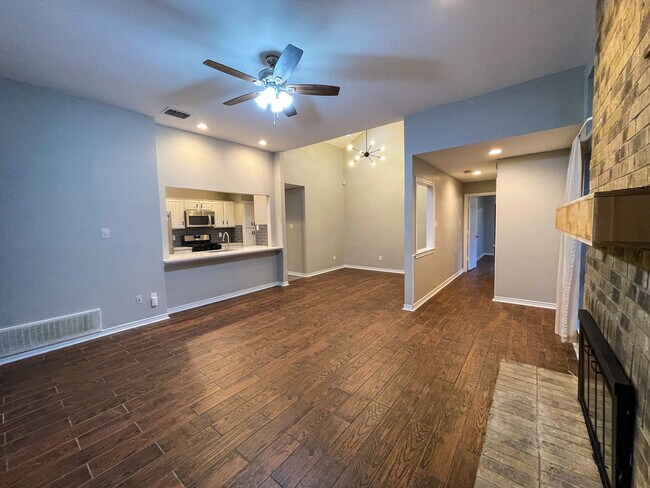 Open concept Kitchen, dining and living room. Features wood look tile throughout the home. scrapped ceilings, fresh interior paint, gas logs in the fire place and all new ceiling fans and light fixtures throughout. - 812 Via Madonna