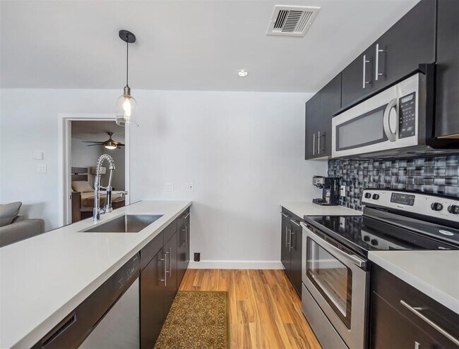 Updated cabinets and quartz countertops make this kitchen stylish, spacious, and functional. - 309 Stratford St