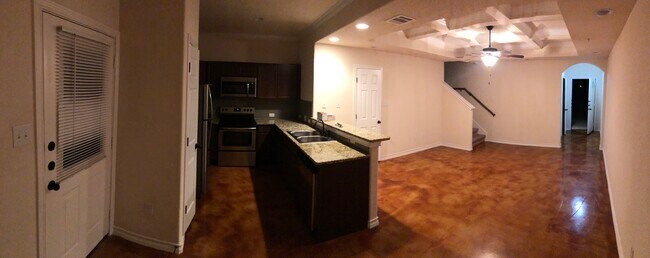 Open downstairs with stained concrete floors. - 16715 Jupiter Haven