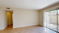 Located at 1241 Arnold Dr in Martinez, CA, this single-story, 3-bedroom, 1-bathroom home offers a practical and comfortable layout. The living room features light hardwood-style flooring and a sliding glass door fitted with vertical blinds that opens to a private outdoor patio, allowing natural light to fill the space. The kitchen is efficiently designed with white cabinetry, ample storage, white appliances including a refrigerator and electric range, and light hardwood-style flooring that ties the common areas together cohesively. The three bedrooms are carpeted for comfort and each feature windows with blinds that provide natural light and outdoor views. The spacious primary bedroom includes direct access to the bathroom and features a vanity area with a large mirror and built-in cabinetry. The shared full bathroom is well-appointed with a single vanity, generous mirror, and a combination tub and shower. Three closets throughout the home provide practical storage solutions. Warm neutral tones on the walls throughout create a clean, bright, and consistent aesthetic across all rooms.