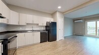 Located at 350 Bobolink Ridge in Ottawa's west end, this well-appointed one-bedroom, one-bathroom unit offers a practical and modern layout across a single floor. Light wood-look flooring runs continuously throughout the space, creating a cohesive and clean aesthetic.

The kitchen is designed for efficiency, featuring crisp white cabinetry extending to the ceiling for generous storage, dark granite-style countertops, and a full suite of black appliances including a range, dishwasher, and refrigerator. An under-cabinet range hood and a double-basin sink with a modern faucet complete the functional workspace.

The open living area is bright and airy, benefiting from a sliding glass door that leads to a private balcony with outdoor views. A wall-mounted ductless mini-split system provides both heating and cooling comfort, complemented by baseboard heaters along the perimeter walls.

The bedroom is a well-sized, quiet retreat featuring a large double-door closet and a window that brings in natural light with views of the surrounding neighbourhood.

The bathroom is finished with warm wood-toned cabinetry, a dark stone countertop with an undermount sink, and a full soaker tub and shower combination with recessed lighting overhead.