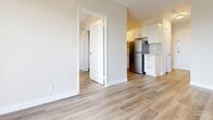 Located at 311 Central Ave in London, Ontario, this one-bedroom unit offers a thoughtfully designed layout across a single floor. Light-toned laminate flooring runs throughout, creating a cohesive and contemporary feel. The living room is generously proportioned, featuring a sliding glass door that opens onto a private balcony with outdoor views, allowing natural light to fill the space. A baseboard heating system provides efficient, consistent warmth throughout. The kitchen is efficiently arranged with crisp white shaker-style cabinetry, marble-look countertops, a subway tile backsplash, and stainless steel appliances including an electric range and full-size refrigerator. The bedroom is a comfortable, well-lit room with a large window, baseboard heating, and a dedicated closet with built-in shelving and hanging rods for practical storage. The bathroom is finished in neutral beige tile and features a combined tub and shower with a curved curtain rod, a white vanity with chrome fixtures, and an oval mirror accented by overhead lighting. The overall aesthetic is clean, modern, and move-in ready, making this unit a practical and appealing option in central London.