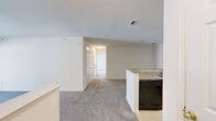 This well-appointed 2-bedroom, 2-bathroom residence in Owings Mills, Maryland offers a thoughtfully designed single-floor layout with a clean, neutral aesthetic throughout. The open-concept kitchen and living area serves as the heart of the home, where a peninsula with granite-look countertops and warm wood cabinetry anchors the kitchen. Black appliances, including a refrigerator, range, microwave, and dishwasher, provide a cohesive look. The adjacent living room features plush carpeting and a sliding glass door that opens to a private balcony overlooking a lush, wooded backdrop, filling the space with natural light. A hallway connects the living area to both bedrooms and bathrooms. The spacious primary bedroom is bathed in natural light from multiple windows and features soft carpeting and a closet. The second bedroom is similarly comfortable, also with carpeting, a double-door closet, and a window. Both bathrooms are finished with tile flooring, wood-tone vanities, and white countertops; one includes a tub-shower combination, while the other offers a separate shower area. Neutral walls and consistent finishes throughout lend the space a bright, cohesive ambiance suited for easy personalization.