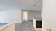 This well-appointed 2-bedroom, 2-bathroom residence in Owings Mills, Maryland offers a thoughtfully designed single-floor layout with a clean, neutral aesthetic throughout. The open-concept kitchen and living area serves as the heart of the home, where a peninsula with granite-look countertops and warm wood cabinetry anchors the kitchen. Black appliances, including a refrigerator, range, microwave, and dishwasher, provide a cohesive look. The adjacent living room features plush carpeting and a sliding glass door that opens to a private balcony overlooking a lush, wooded backdrop, filling the space with natural light. A hallway connects the living area to both bedrooms and bathrooms. The spacious primary bedroom is bathed in natural light from multiple windows and features soft carpeting and a closet. The second bedroom is similarly comfortable, also with carpeting, a double-door closet, and a window. Both bathrooms are finished with tile flooring, wood-tone vanities, and white countertops; one includes a tub-shower combination, while the other offers a separate shower area. Neutral walls and consistent finishes throughout lend the space a bright, cohesive ambiance suited for easy personalization.