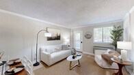 Located at 1365 Gatewood Dr in Auburn, AL, this well-appointed one-bedroom, one-bathroom unit offers a thoughtfully designed single-floor layout that maximizes every square foot. Light-toned walls and light wood-style flooring flow throughout, creating a bright, cohesive atmosphere.

The living room serves as the heart of the home, featuring crown molding, a textured ceiling, and a large window that floods the space with natural light. A private exterior door provides convenient direct access from the living area. An adjacent dining space connects seamlessly, making the open layout ideal for both relaxing and entertaining.

The galley-style kitchen is efficiently designed with gray shaker cabinetry, granite-look countertops, a stainless steel dishwasher, range, microwave, and refrigerator, all complemented by the same light hardwood-style flooring.

The generously sized bedroom offers a large window with outdoor views, dual closet access via classic double doors, and an additional walk-in closet accessible through a connecting hallway — providing ample storage. The full bathroom includes a granite-top vanity with gray cabinetry and a tub/shower combination. A hallway connects all rooms, rounding out this functional and comfortable home.