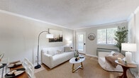 Located at 1365 Gatewood Dr in Auburn, AL, this well-appointed one-bedroom, one-bathroom unit offers a thoughtfully designed single-floor layout that maximizes every square foot. Light-toned walls and light wood-style flooring flow throughout, creating a bright, cohesive atmosphere.

The living room serves as the heart of the home, featuring crown molding, a textured ceiling, and a large window that floods the space with natural light. A private exterior door provides convenient direct access from the living area. An adjacent dining space connects seamlessly, making the open layout ideal for both relaxing and entertaining.

The galley-style kitchen is efficiently designed with gray shaker cabinetry, granite-look countertops, a stainless steel dishwasher, range, microwave, and refrigerator, all complemented by the same light hardwood-style flooring.

The generously sized bedroom offers a large window with outdoor views, dual closet access via classic double doors, and an additional walk-in closet accessible through a connecting hallway — providing ample storage. The full bathroom includes a granite-top vanity with gray cabinetry and a tub/shower combination. A hallway connects all rooms, rounding out this functional and comfortable home.