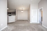 Located at 302 Walden Landing Dr in Hampton, Georgia, this single-floor residence offers a well-designed open-concept layout that seamlessly connects the main living areas. The kitchen is a standout feature, equipped with dark espresso-toned cabinetry, sleek white countertops, black appliances including an electric range and built-in microwave, and wood-look flooring that adds warmth and durability. A peninsula with a sink opens directly to the dining and living areas, enhancing the sense of connectivity throughout the space.

The living room is generously sized, featuring plush carpeting, a ceiling fan, and a glass-panel door that invites natural light while providing access to the outdoors. Vaulted ceilings in the main living area contribute to an airy, open ambiance. The bedrooms are carpeted and well-proportioned, each offering natural light through window blinds and ceiling fans for year-round comfort. At least one bedroom includes a walk-in closet for additional storage.

The bathrooms feature wood-look tile flooring, dark vanity cabinetry with white countertops, and tub-shower combinations with clean white surrounds. Overall, the space presents a neutral, move-in-ready palette with consistent finishes throughout, making it a practical and comfortable residence in Hampton, GA.
