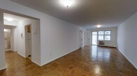 This single-floor residence at 425 offers a thoughtfully laid-out living space defined by timeless design and warm, inviting interiors. The standout feature throughout is the classic parquet wood flooring, arranged in a rich geometric pattern that adds texture and character to every room.

The open living and dining area is generously proportioned, with clean white walls that create a bright, neutral canvas. Flush-mounted ceiling fixtures provide ambient lighting, complementing the natural light that filters in through large windows. French doors with glass panes serve as an elegant dividing element, connecting the living spaces while maintaining an open, airy feel.

Toward the front of the unit, natural light pours in through a wide window fitted with an in-wall air conditioning unit, ensuring year-round comfort. The open layout allows for flexible furniture arrangements, making the space highly functional for everyday living and entertaining.

The kitchen area is accessible from the main living space, maintaining a cohesive flow throughout the floor plan. White walls and clean architectural lines give the residence a classic, understated aesthetic that provides a versatile backdrop for a variety of interior styles. Overall, this space combines practical functionality with timeless design elements.