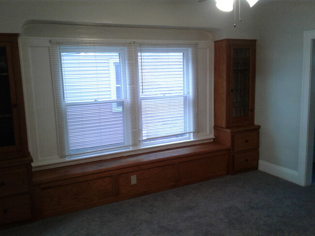 The large formal dining room with newer carpet and paint. Ceiling fan too. - 1673 Victoria Ave