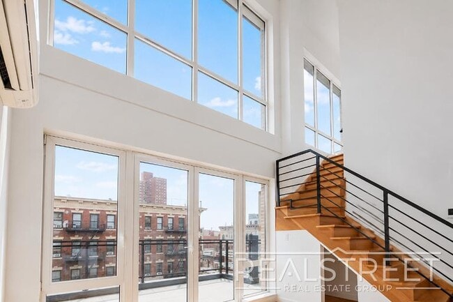 Building Photo - Sun-Filled Penthouse Duplex with Massive Private Terrace & Bonus Storage Room