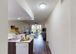 Located at 19455 NE Tenth Ave in Miami, FL, this single-floor residence offers a well-designed layout that balances comfort and functionality. The open-concept kitchen is equipped with white cabinetry, a breakfast bar with modern seating, a full suite of appliances, and recessed lighting — flowing seamlessly into the dining and living areas. The living room features wood-look flooring, a ceiling fan, and large sliding glass doors that fill the space with natural light and provide direct access to a private balcony overlooking lush greenery. The primary bedroom is generously sized with a ceiling fan, wood-look flooring, mirrored closet doors, and its own sliding glass door to the balcony. A second bedroom offers flexibility, currently configured as a youth space with a bunk bed, ceiling fan, and nautical-themed décor. Two full bathrooms feature clean white finishes, dark wood vanity cabinetry, glass-enclosed showers, and tile flooring. Throughout the residence, a consistent use of wood-look flooring, neutral wall tones, and textured ceilings creates a cohesive and inviting atmosphere well-suited to Miami's vibrant lifestyle.