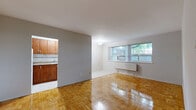 Located at 1284 Danforth Road in Toronto's Scarborough neighbourhood, this 2-bedroom, 1-bathroom unit offers a practical and well-organized single-floor layout. Warm parquet wood flooring runs throughout the living areas and bedrooms, lending a classic character to the space.

The open living room is generously proportioned, featuring large windows with vertical blinds that bring in natural light and offer outdoor views. A radiator heating unit ensures warmth during colder months. The living area connects openly to the kitchen, which is equipped with warm-toned wood cabinetry, a tile backsplash, a double-coil electric stove, and a full-size refrigerator, with light-toned vinyl flooring underfoot.

Both bedrooms are comfortably sized, each featuring the same parquet flooring found throughout the unit. The primary bedroom includes a double-door closet, while both rooms benefit from windows with natural light and radiator heating. A connecting hallway provides clear flow between the private and common areas.

The bathroom is finished with pale yellow wall tiles, a classic mosaic tile floor, a soaking bathtub with overhead shower, a wall-mounted sink, and a mirrored medicine cabinet. The overall ambiance is clean, functional, and well-maintained, making this a solid residential option in east Toronto.