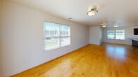 This well-appointed 2-bedroom, 2-bathroom single-floor residence at 770 E Ashland St in Brockton, MA offers a clean, modern layout designed for comfortable everyday living. Warm honey-toned hardwood floors flow throughout the main living areas and both bedrooms, creating a cohesive and inviting atmosphere. The open-concept living room is bright and airy, with large windows and a sliding glass door that opens to a private outdoor deck, filling the space with abundant natural light and providing a seamless indoor-outdoor connection.

The kitchen is a standout feature, showcasing rich dark-espresso cabinetry, granite countertops, a classic white subway tile backsplash, and a peninsula with pendant lighting that doubles as additional prep and seating space. White appliances, including a gas range, microwave, and refrigerator, complement the kitchen's clean aesthetic, while tile flooring and a window above the sink add practicality and light.

Both bedrooms are comfortably sized, each featuring hardwood floors and windows that invite natural light. The two bathrooms are well-finished with granite-topped vanities and dark cabinetry — one offers a walk-in shower, and the other a full tub-shower combination, both tiled in neutral tones. The overall design is clean, modern, and move-in ready.