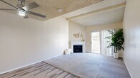 Located at 1840 S Nelson St in West Covina, California, this single-story 2-bedroom, 1-bathroom home offers a well-organized and functional layout. The living room is a standout space, featuring vaulted ceilings with an exposed beam, a textured ceiling, a cozy fireplace with a white mantle, and a sliding glass door that fills the room with natural light and provides outdoor access. The flooring transitions from wood-look laminate to plush carpet, adding warmth and visual variety. The kitchen is bright and modern, outfitted with white cabinetry, light stone countertops, stainless steel appliances including a dishwasher and microwave, and a skylight that enhances the airy feel. A dining area sits adjacent to the kitchen and living spaces, creating a cohesive open flow. The spacious primary bedroom features soft carpet, multiple windows with vertical blinds, and generous closet space with sliding doors. The second bedroom is comfortably sized with a window that brings in natural light. Both bedrooms have easy access to the full bathroom, which includes a tub-shower combination. The home also features a hallway connecting the main living areas, with four closets providing ample storage throughout.