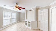 Located at 1925 N Third St in Baton Rouge, Louisiana, this single-floor, 2-bedroom, 2-bathroom home offers a practical and comfortable layout. The living room features light ceramic tile flooring, crown molding, a ceiling fan with light fixture, and a built-in cabinet unit with glass doors, adding a distinctive architectural touch. Natural light filters through blinded windows, creating a bright and welcoming atmosphere.

The kitchen is well-appointed with rich wood cabinetry, tile countertops, a diagonal tile backsplash, and a full suite of black appliances including a range, microwave, dishwasher, and refrigerator. Both bedrooms feature warm hardwood-style flooring, ceiling fans, and generous closets with bifold doors. The spacious primary bedroom includes its own en-suite bathroom access. Each bedroom benefits from natural light through windows with blinds.

The two bathrooms are finished with tile flooring and white cabinetry. The primary bath includes a wide vanity with a large mirror and overhead lighting, plus a tiled shower and additional storage. The second bathroom features a corner vanity and a combination tub/shower. A connecting hallway ties the layout together efficiently, making this a well-organized and functional home.