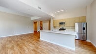 Located at 850 Pacific Street in Stamford, CT, this two-story home offers a well-designed layout across two generously sized floors. The main level features an open-concept kitchen and living area, where warm wood-look flooring flows throughout the space. The kitchen is a standout, equipped with stainless steel appliances, light wood cabinetry, and a large white waterfall island with an integrated sink — ideal for both cooking and entertaining. The living area is bright and airy, complemented by a dedicated entrance and convenient staircase access to the upper level.

Upstairs, the layout includes two bedrooms, with the spacious primary bedroom offering large floor-to-ceiling windows that flood the room with natural light and provide views of the surrounding Stamford streetscape. The upper level also features well-appointed hallways and ample closet storage, including walk-in closets fitted with wire shelving systems. Three full bathrooms are distributed across the home, each finished with clean white fixtures and matching wood-look flooring. A dedicated laundry room adds everyday convenience. The home also includes a private outdoor patio, perfect for enjoying the urban neighborhood setting.
