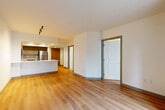 Located at 1906 7th Ave in the heart of Seattle, this well-appointed one-bedroom, one-bathroom unit offers a thoughtfully designed open-concept layout with light hardwood-style flooring flowing seamlessly throughout the space. The combined living, dining, and kitchen area serves as the central hub of the unit, providing an efficient and cohesive space for both entertaining and daily living. The kitchen is outfitted with taupe shaker-style cabinetry, a full suite of stainless steel appliances including a refrigerator, range, microwave, and dishwasher, a subway tile backsplash, and a large peninsula featuring a white quartz countertop — perfect for casual dining or meal prep. The open living and dining area benefits from natural light streaming through a wide floor-to-ceiling window, offering views of the surrounding Seattle skyline. The spacious bedroom continues the warm flooring and neutral palette, with large windows that invite abundant natural light. Three closets provide generous storage throughout the unit. The bathroom is finished with large-format tile flooring, a taupe vanity with white countertop, and a well-lit mirror. Clean lines, neutral tones, and modern finishes define the overall aesthetic of this urban Seattle residence.