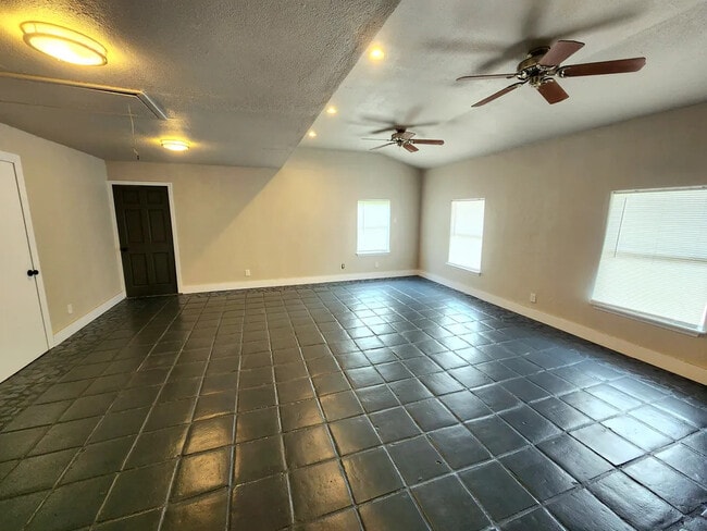 Huge living room that will hold all your furniture and wall size big enough for large a Large TV. - 1727 Austin St