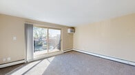This well-appointed 2-bedroom, 1-bathroom residence in Prospect Park, PA offers a comfortable and functional single-floor layout. The living room is bright and inviting, featuring plush carpeting, a ceiling fan, and a large sliding glass door that opens to a private balcony overlooking mature trees — filling the space with natural light. A pass-through opening connects the living and dining areas to the kitchen, creating an open, connected feel.

The kitchen is thoughtfully updated with crisp white cabinetry, a tile backsplash with decorative mosaic accents, light wood-look flooring, and full appliances including a range and refrigerator. A circular overhead light fixture adds a clean, modern touch.

Both bedrooms are carpeted and feature neutral warm-toned walls. The spacious primary bedroom includes a sliding-door closet and a window with natural light. Additional closets throughout the unit — four in total — provide generous storage. A central hallway connects all rooms efficiently.

The bathroom is finished with tile flooring, a tiled tub/shower surround with a curved rod, and a white vanity with an undermount sink and clean countertop. The overall aesthetic throughout is neutral and move-in ready, with baseboard heating units present in multiple rooms.