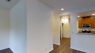 This two-floor space presents a thoughtfully designed interior with a clean, modern aesthetic. The interior is finished with neutral, light-toned walls that create a bright and welcoming atmosphere throughout. Rich, dark hardwood flooring runs continuously through the hallways and living areas, adding warmth and a sense of cohesion to the overall design.

Recessed ceiling lighting provides even, functional illumination across the space, complementing the natural brightness of the rooms. The hallway features classic six-panel interior doors and crisp white baseboards that offer a timeless, polished look against the dark flooring. The layout flows smoothly between areas, with well-defined transitions connecting the rooms across both floors.

The overall ambiance is clean and move-in ready, with a neutral color palette that lends itself well to a variety of interior design styles. The combination of contemporary recessed lighting, hardwood flooring, and traditional door and trim details gives the space a balanced character — both functional and visually appealing. The two-floor layout offers a clear separation of living areas, providing versatility in how the space can be utilized.