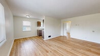 Located at 14 Dean Pl in Dayton, Ohio, this single-floor, 2-bedroom, 1-bathroom home offers a clean and efficiently designed layout. Light wood flooring flows consistently throughout the entire space, creating a cohesive and warm aesthetic from room to room.

The combined kitchen and living area provides a practical and open feel. The galley-style kitchen is equipped with dark brown cabinetry offering ample storage, light countertops, a double-basin sink, and a white electric range, all complemented by a window that brings in natural light.

The living room is bright and open, with a large window overlooking the surrounding neighborhood, allowing for a comfortable flow of natural light throughout the day.

The primary bedroom is a well-proportioned space featuring dual windows that frame views of the surrounding greenery, filling the room with natural light. The second bedroom also includes a window with outdoor views, a closet, and access to the hallway. Both bedrooms maintain the consistent light wood flooring seen throughout the home.

The bathroom is clean and functional, featuring a full tub and shower combination with a built-in shelving niche. A hallway connects all rooms, ensuring a logical and accessible floor plan throughout the home.