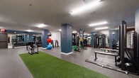 Located at 808 Chapel Street in New Haven, Connecticut, this fitness center offers a generously sized, single-floor facility designed to accommodate a wide range of workout routines. The space features a clean, modern aesthetic with bold blue accent columns, white walls, and durable speckled rubber flooring throughout, complemented by strips of artificial turf that define functional training zones.

The strength training area is well-appointed with a full rack of dumbbells, a power rack loaded with Olympic weight plates, a Smith machine, cable machines, and a dedicated bench press station. Medicine balls and stability balls in multiple sizes are neatly organized near the turf areas, supporting dynamic and core-focused workouts.

The cardio section lines one wall and includes multiple treadmills, elliptical trainers, stair climbers, and stationary bikes, each equipped with individual screens. Floor-to-ceiling mirrors along this wall amplify the sense of space and allow users to monitor their form during exercise.

A TRX suspension training station and functional fitness equipment round out the training options, while a vending machine provides convenient access to snacks and beverages. The facility is brightly lit with recessed and panel lighting throughout, creating a well-illuminated and energizing environment. Restroom access is available on-site, making this a fully self-contained fitness destination in the heart of New Haven.