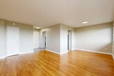 Located at 4020 Boul St-Jean in Dollard-Des-Ormeaux, Quebec, this well-appointed 2-bedroom, 2-bathroom unit offers a functional and comfortable single-floor layout. Warm honey-toned hardwood flooring flows throughout the living areas and bedrooms, creating a cohesive and inviting atmosphere.

The living room is generously sized, featuring large sliding windows that frame pleasant views of the surrounding greenery and neighbourhood, allowing abundant natural light to fill the space. A baseboard heating system runs along the exterior walls for year-round comfort.

The kitchen is finished with white cabinetry, a tasteful grey tile backsplash, a stainless steel range, and light-toned ceramic tile flooring, offering a clean and modern aesthetic. A direct entryway nearby provides convenient access.

The primary bedroom is a spacious retreat with hardwood floors, a dedicated closet, and a private ensuite bathroom. The ensuite features a white vanity with an integrated sink, a large mirror, and tile flooring. A second bedroom is also well-proportioned with its own access to closet space. The second bathroom is clean and neutral in finish, consistent with the unit's overall modern, understated design.

Two closets throughout the unit provide practical storage solutions, completing this efficient and bright living space.