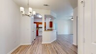 Located at 3525 S Sam Houston Pkwy E in Houston, TX, this single-floor, 3-bedroom, 2-bathroom home offers a bright and functional layout with thoughtful design details throughout. Light-toned wood-look flooring runs consistently across the living areas, kitchen, and bedrooms, creating a cohesive and clean aesthetic.

The open-concept living and kitchen area is anchored by soaring ceilings and a chandelier, with an elegant arched doorway adding architectural character. A ceiling fan keeps the living space comfortable, while a sliding glass door opens directly onto a private balcony, inviting natural light and outdoor views. The kitchen features warm wood cabinetry, tile backsplash, white appliances, and a peninsula breakfast bar that bridges the kitchen and living area seamlessly. An adjacent pantry provides additional storage.

The primary bedroom is generously sized with its own en-suite bathroom, while the two additional bedrooms each offer ceiling fans and multiple windows that bring in ample natural light. The bathrooms include vanities with updated cabinetry and a tub-shower combination. A dedicated laundry room with full hookups adds everyday convenience. With seven closets distributed throughout, storage is plentiful. The overall ambiance is clean, airy, and move-in ready.
