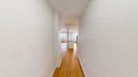 Located on the 10th floor at 565 Avenue Rd in Toronto's prestigious Forest Hill neighbourhood, this thoughtfully designed unit offers a comfortable and efficient single-floor layout. Warm honey-toned hardwood flooring flows seamlessly throughout the space, lending a cohesive and inviting character to every room.

The open-concept kitchen serves as the functional heart of the unit, anchored by a peninsula with a granite-topped breakfast bar and an integrated sink. Crisp white shaker-style cabinetry extends to the ceiling, providing generous storage, while a classic subway tile backsplash adds a clean, timeless detail. Stainless steel appliances — including a full-size refrigerator, electric range, and over-the-range microwave — complete the well-equipped kitchen. A large window floods the area with natural light and offers elevated views of the surrounding cityscape and lush tree canopy along Avenue Road.

The bedroom area is a bright, open room with neutral white walls and continued hardwood flooring, offering a calm and versatile space.

The bathroom features a white vanity with a granite countertop, a large mirror, and consistent hardwood flooring, maintaining the unit's clean and modern aesthetic throughout.

A private balcony provides sweeping views of Avenue Road and the Toronto skyline, framed by abundant greenery.