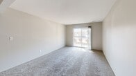 This single-floor, 2-bedroom, 2-bathroom residence in Fort Wayne, Indiana offers a practical and comfortable layout. The carpeted living room is bright and open, featuring a sliding glass door that floods the space with natural light and leads directly to a private patio. Adjacent to the living room, a dedicated dining area provides a natural flow for everyday living and entertaining.

The kitchen is equipped with wood-toned cabinetry, dark countertops, a built-in dishwasher, and hardwood-style flooring, offering functional workspace and ample storage.

Both bedrooms are generously sized and finished with soft carpet and neutral walls. The primary bedroom features a large louvered bi-fold closet and direct access to a bathroom. The second bedroom includes a window that brings in natural light and outdoor views. Notably, the unit features five closets in total, providing exceptional storage throughout.

The bathrooms include one full bath with a dual-sink vanity, stacked washer/dryer unit, hardwood-style flooring, and a shower/tub combo. The layout is completed by a connecting hallway that ties each room together efficiently, creating a cohesive and well-organized living environment ideal for those seeking comfort and practicality in Fort Wayne.