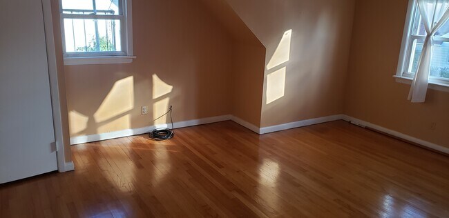 Large Living room with coat closet, plenty natural light with 3 windows. - 66 Cherry St