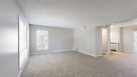 Located at 283 Van Gordon St in Lakewood, Colorado, this two-story residence offers 2 bedrooms and 2 bathrooms across two well-proportioned floors. The main level houses the living room, dining room, and kitchen, all connected by a hallway. The living room features neutral-toned carpet, a textured ceiling, and multiple windows that fill the space with natural light and views of surrounding greenery. The kitchen is outfitted with white shaker-style cabinetry, granite-look countertops, stainless steel appliances including a refrigerator, range, and dishwasher, and wood-look flooring. A private balcony extends the living space outdoors. The upper floor hosts both bedrooms, each carpeted and bathed in natural light from multiple windows. The generously sized primary bedroom includes dual louvered bi-fold closets, offering ample storage. Both bathrooms are finished with wood-look flooring, white cabinetry, and speckled stone countertops; one features a full tub-shower combination. A dedicated laundry area and utility room add everyday convenience. Neutral wall tones and consistent finishes throughout create a cohesive, move-in-ready aesthetic.